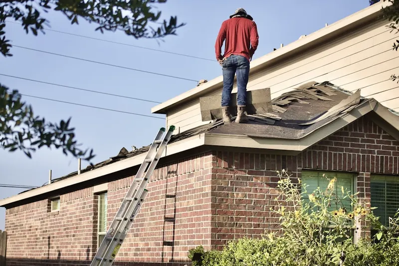 Professional roofer working on a residential roof in Riverwoods Country Club Estates